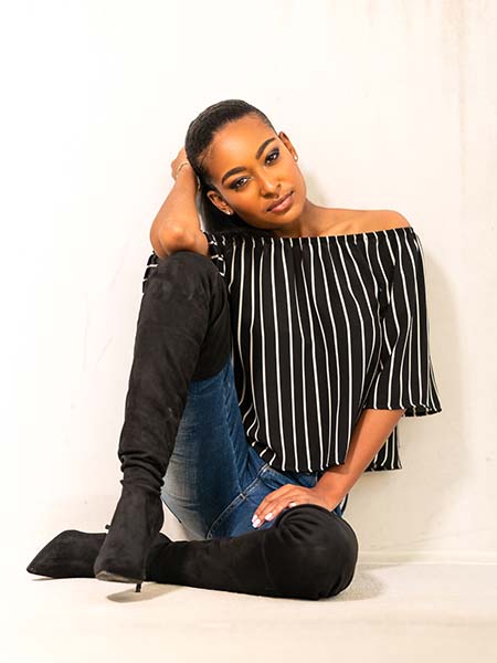 Woman posing against a wall